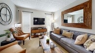 Located at 6925 Roswell Rd in Sandy Springs, GA, this thoughtfully designed one-bedroom, one-bathroom residence offers an efficient and comfortable layout across a single floor. The open-concept living and dining area is bathed in natural light from large sliding glass doors that offer outdoor views, creating an inviting and airy atmosphere. The living room features neutral-toned walls, plush carpeting, and a textured ceiling, providing a warm and relaxed setting. The adjacent dining area accommodates a full dining set and connects seamlessly to the rest of the space.

The kitchen is well-equipped with rich dark cabinetry, granite-style countertops, a subway tile backsplash, and a full suite of stainless steel appliances including a refrigerator, range, dishwasher, and microwave. Wood-look flooring runs throughout the kitchen, which also provides direct access to an in-unit laundry closet housing a full-size washer and dryer.

The bedroom is a serene retreat with plush carpet, a ceiling fan, natural light from a window, and ample space for a large bed and dresser. A dedicated closet offers generous storage. The bathroom features a full tub and shower combination with clean, bright finishes. Overall, the space delivers a practical yet comfortable living environment in a desirable Sandy Springs location.