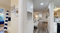 Located at 100 Camellia Ln in Stonecrest, GA, this single-floor residence offers 2 bedrooms and 4 bathrooms within a smartly utilized footprint. The living room serves as the heart of the home, featuring wood-look plank flooring, a ceiling fan, and large windows and glass doors that invite natural light and offer views of the outdoors. The space flows naturally into a dining area, creating a cohesive and welcoming common area.

The kitchen is outfitted with crisp white shaker-style cabinetry, light countertops, and black appliances including a range, dishwasher, and refrigerator, all set atop matching wood-look flooring. The design is both functional and visually clean.

Both bedrooms are carpeted and feature ceiling fans, with the primary bedroom offering a comfortable, well-proportioned retreat alongside a spacious walk-in closet with multi-tiered wire shelving. A second walk-in style closet provides additional storage. The bathrooms are finished with white cabinetry, wide vanity mirrors, and tub-shower combinations, with the primary bath boasting a dual-sink vanity.

Additional conveniences include a dedicated laundry area and well-placed hallways that keep the layout open and accessible. Neutral tones and consistent finishes throughout create a cohesive, move-in-ready aesthetic.