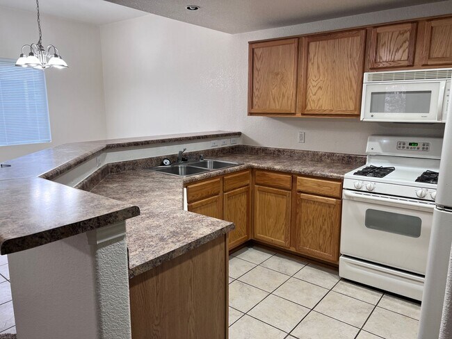 Building Photo - Wonderful 3 Br condo in gated community with the major appliances and 1 car garage.