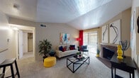Located at 16550 Henderson Pass in San Antonio, Texas, this single-floor residence offers a well-designed layout that balances comfort and functionality. The living room is a standout space, characterized by soaring vaulted ceilings with a textured finish that lend an airy, open feel. A brick fireplace anchors one wall, while a sliding glass door floods the room with natural light and provides outdoor access. Plush carpeting runs throughout the living areas, adding warmth underfoot.

The open-concept design connects the living room to a dedicated dining area and a pass-through kitchen, creating a seamless flow ideal for entertaining. The galley-style kitchen is well-appointed with rich dark cabinetry, granite-look countertops, wood-look flooring, and black appliances including a range, microwave, and refrigerator. A breakfast bar with bar stool seating bridges the kitchen and living space.

The bedroom is generously sized with carpeted floors, a ceiling fan, and a closet, providing a comfortable private retreat. The bathroom features matching dark cabinetry, granite-look counters, a large mirror, and wood-look flooring. A dedicated in-unit laundry area with side-by-side washer and dryer hookups adds everyday convenience to this thoughtfully appointed home.