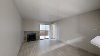Located at 407 Greens Rd in Houston, TX, this 2-bedroom, 3-bathroom unit offers a practical and well-organized single-floor layout. Light-toned tile flooring runs consistently throughout, lending a clean, cohesive look to every room.

The open living area is anchored by a stone-surround fireplace and connects seamlessly to the kitchen and dining space. A sliding glass door provides access to an outdoor area, allowing natural light to fill the room. The kitchen features a peninsula breakfast bar with a white countertop, black appliances including a refrigerator and range, cabinetry with an overhead vent hood, and tile flooring. A ceiling fan is positioned at the kitchen-living transition, enhancing airflow and comfort.

Both bedrooms are bright and modestly sized, each benefiting from windows with blinds that bring in natural light. The primary bedroom includes its own dedicated closet. The three bathrooms are finished with light gray cabinetry, white countertops, and tile flooring. One bathroom features a soaking tub and a wide vanity with a large mirror, while others are fitted with showers and matching fixtures.

A central hallway connects the main living areas to the bedrooms and bathrooms, keeping the layout efficient. The neutral color palette and consistent finishes throughout give the unit a clean, move-in-ready appearance.