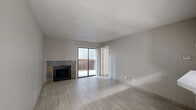 Located at 407 Greens Rd in Houston, TX, this 2-bedroom, 3-bathroom unit offers a practical and well-organized single-floor layout. Light-toned tile flooring runs consistently throughout, lending a clean, cohesive look to every room.

The open living area is anchored by a stone-surround fireplace and connects seamlessly to the kitchen and dining space. A sliding glass door provides access to an outdoor area, allowing natural light to fill the room. The kitchen features a peninsula breakfast bar with a white countertop, black appliances including a refrigerator and range, cabinetry with an overhead vent hood, and tile flooring. A ceiling fan is positioned at the kitchen-living transition, enhancing airflow and comfort.

Both bedrooms are bright and modestly sized, each benefiting from windows with blinds that bring in natural light. The primary bedroom includes its own dedicated closet. The three bathrooms are finished with light gray cabinetry, white countertops, and tile flooring. One bathroom features a soaking tub and a wide vanity with a large mirror, while others are fitted with showers and matching fixtures.

A central hallway connects the main living areas to the bedrooms and bathrooms, keeping the layout efficient. The neutral color palette and consistent finishes throughout give the unit a clean, move-in-ready appearance.