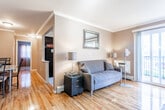 Located at 1480 Parkside Ave in Ewing, NJ, this single-floor residence offers a well-organized and comfortable layout designed for everyday living. The living room serves as the heart of the home, featuring gleaming hardwood floors, crown molding, and a set of French doors that open to a private balcony, flooding the space with natural light and offering outdoor views. The kitchen is efficiently arranged with dark cabinetry, black appliances including a gas range and refrigerator, and a window that brings in additional natural light. A dedicated dining area adjoins the living space, showcasing hardwood flooring, crown molding, and room for a full dining set — ideal for both casual meals and entertaining. The bedrooms are calm and restful, each featuring hardwood floors, large windows with curtains that allow for generous natural light, and baseboard heating. The bathroom is well-appointed with tile flooring, a vanity with storage, and a bathtub and shower combination enclosed by sliding glass doors. Throughout the residence, a consistent neutral color palette and warm lighting create a cohesive and inviting atmosphere, making this a practical and comfortable home in the Ewing, NJ community.