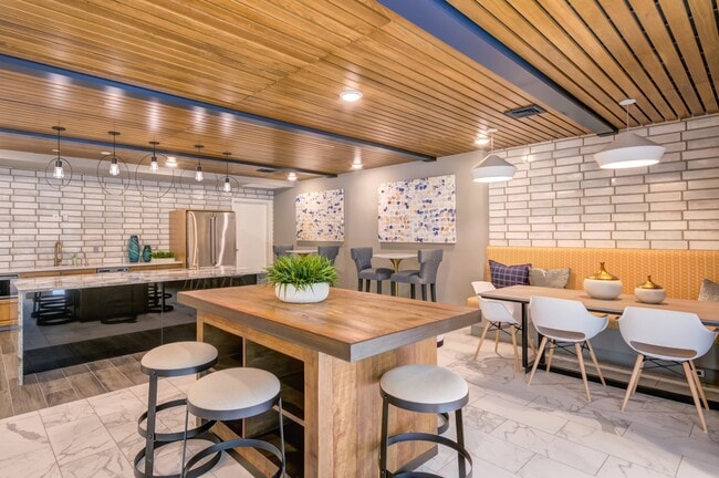 Gather, cook, or unwind in our stylish community kitchen and dining space designed for connection and comfort. - The Heights at Goose Creek Village