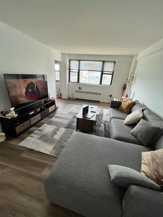 Living room with NYC view - 6515 Boulevard E