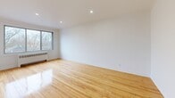 Located on the third floor at 7211 Avenue Fielding in Montréal's NDG neighbourhood, this 2-bedroom, 1-bathroom unit offers a well-organized layout across a single floor. Warm-toned hardwood flooring runs consistently throughout the space, contributing to a bright and cohesive aesthetic enhanced by white walls and recessed lighting.

The entry hallway provides a clear transition into the main living areas. The living room is generously proportioned, featuring a window that brings in natural light and views of the surrounding residential streetscape, along with a radiator heating unit. A balcony accessible from the unit offers an elevated view of the tree-lined neighbourhood.

The primary bedroom is a well-sized room with hardwood floors, a window overlooking the street, and a radiator. The second bedroom is comparably finished, with recessed lighting and access to adjacent spaces. Both rooms feature classic panel-style white doors and clean wall finishes.

The bathroom stands out as a notable renovation highlight, clad in large-format marble-effect tiles from floor to ceiling. It includes a full soaking bathtub, a white vanity with under-cabinet storage, and a frosted sliding window for ventilation and privacy.