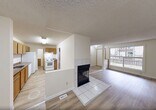 This single-story home in Edmonton offers 980 square feet of living space, efficiently divided into four bedrooms, a bathroom, and a combined kitchen and living area. The property boasts modern amenities and a practical layout. The kitchen is equipped with white appliances, including a refrigerator and stove, complemented by wooden cabinets and marble-effect countertops. A dishwasher is conveniently integrated into the kitchen design.

Throughout the home, light-colored hardwood flooring creates a sense of continuity and brightness. The bathroom features a bathtub-shower combination with white tiling, providing both functionality and a clean aesthetic. Each bedroom offers ample space, with one room measuring 100 square feet, ideal for use as a primary bedroom.

The living area includes a fireplace, adding warmth and character to the space. Large windows in some rooms allow natural light to flood the interior, enhancing the open feel of the home. The property also includes three closets for storage, ensuring practical living solutions. With its neutral color palette and modern fixtures, this home presents a blank canvas for personalization while offering essential comforts for everyday living.