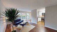 Located at 811 Bounty Dr in Foster City, CA, this single-floor residence offers a thoughtfully designed layout with clean, modern finishes throughout. Warm hardwood-style flooring runs continuously across the living spaces, creating a cohesive and inviting atmosphere.

The open-concept living area is anchored by large sliding glass doors that fill the space with natural light and provide direct access to an outdoor patio, where lush greenery creates a pleasant backdrop. The living room flows seamlessly toward the kitchen, which is separated by a partial wall and features white cabinetry, subway tile backsplash, grey composite countertops, and a full suite of stainless steel appliances including a range, over-the-range microwave, and refrigerator. A pass-through counter opening connects the kitchen to an adjacent dining or flex area fitted with a ceiling fan.

The bedroom is calm and neutral-toned, offering a serene retreat with soft grey walls and a mirrored sliding-door closet with built-in shelving for organized storage. The full bathroom is finished with a grey vanity countertop, a wide mirror, white cabinetry, and a shower-tub combination.

A notable convenience is the in-unit stacked washer and dryer, neatly integrated into the living space. The overall aesthetic is clean, light, and functional.