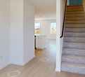 This contemporary residence at 12612 Thyme Pass, Converse, Texas, offers 1980 square feet of living space across two floors. The home boasts four bedrooms, including a generous 200 square foot primary suite, and three full bathrooms. The ground floor spans 860 square feet, while the upper level provides 1130 square feet of space.

The interior showcases a modern, open-concept design with a combined kitchen and living area. The kitchen features sleek white cabinetry, stainless steel appliances, and a spacious island with a sink. Light-colored flooring throughout creates a bright, airy atmosphere. Large windows in the bedrooms and living areas allow ample natural light and offer views of the surrounding neighborhood.

Storage solutions include built-in closets with shelving systems. The home also includes a garage with paneled walls and an automatic door opener. Bathrooms are equipped with modern fixtures, including a walk-in shower.

The exterior is finished in blue siding, complemented by a wooden fence enclosing the backyard. The property offers potential for landscaping and outdoor living spaces. This well-designed home provides a balance of functionality and contemporary style, ideal for modern family living.