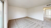 Located at 3535 Marconi Ave in Sacramento, CA, this 2-bedroom, 1-bathroom residence offers a thoughtfully organized single-floor layout filled with natural light throughout. The open living and dining area is bright and airy, featuring neutral carpet, a ceiling fan, and sliding glass doors that lead to a private balcony with outdoor views. A skylight in the transitional space between the kitchen and dining area adds additional natural illumination. The galley-style kitchen is well-appointed with white cabinetry, granite-style countertops, a stainless steel sink, electric range, built-in microwave, and a full-size refrigerator, all set above wood-style flooring. Both bedrooms are carpeted and receive ample natural light through large windows with vertical blinds. The spacious primary bedroom includes a sliding-door closet, with additional closets distributed throughout the unit for generous storage. The full bathroom features a granite-style vanity countertop with a large mirror, a soaking tub with shower, and wood-style flooring. A dedicated utility room, hallway, and entrance complete this well-rounded, efficiently designed home in Sacramento's Marconi corridor.