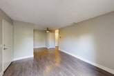 Located at 655 Enterprise Dr in Rohnert Park, CA, this one-bedroom, one-bathroom single-floor unit offers a thoughtfully organized layout across a compact but functional footprint. The living room features durable wood-style flooring, neutral gray walls, a textured ceiling, and a ceiling fan, creating a comfortable and well-ventilated space. An open entryway connects the living area to the combined dining room and kitchen, which is outfitted with white shaker cabinets, gray countertops, a stainless steel gas range, dishwasher, refrigerator, and a window that brings in natural light. The bedroom is carpeted for warmth and comfort, includes a sliding mirrored closet, an additional closet, and a window with views of surrounding greenery. The bathroom features a clean white tub and shower surround with chrome fixtures. Additional highlights include a dedicated laundry area, a utility room, a hallway connecting the main spaces, and a private patio for outdoor enjoyment. The unit's consistent neutral palette and mix of wood-style and carpeted flooring provide a cohesive, move-in-ready aesthetic throughout.