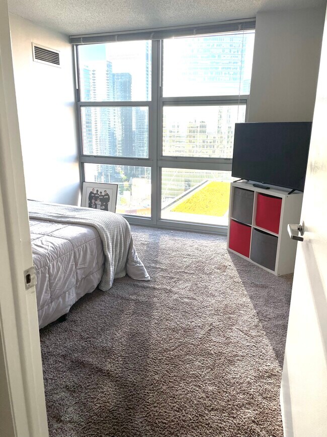 Bedroom 1 w/ Floor to Ceiling Windows - 600 W Lake St