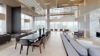 This striking high-rise amenity space delivers an exceptional blend of modern architecture and refined interior design, set against a breathtaking urban skyline backdrop. Floor-to-ceiling glass walls define the space throughout, flooding every area with abundant natural light and framing panoramic city views that serve as a dramatic, ever-present feature.

The grand lounge area is anchored by soaring double-height ceilings and expansive glazing that opens the interior to the cityscape beyond. Large-format light-toned tile flooring runs throughout the main level, lending a clean, cohesive aesthetic. Thoughtfully arranged seating areas feature contemporary sofas, lounge chairs, and coffee tables in a sophisticated neutral palette, creating inviting zones for both relaxation and social interaction.

A formal dining area accommodates a long, dark conference-style table surrounded by modern upholstered chairs, complemented overhead by a striking sculptural chandelier. Warm wood ceiling accents and vertical slatted wood panels introduce natural texture and warmth, balancing the cool tones of the glass and tile.

The lobby-level lounge boasts a two-story glass atrium ceiling with direct access to an outdoor terrace visible through glass doors, extending the living space into the open air. Throughout the space, carefully selected lighting fixtures — including oversized pendant lamps — enhance the upscale ambiance, making this a truly elevated environment.