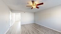 Located at 3000 Fountainhead Circle in Melbourne, Florida, this two-story, three-bedroom, three-bathroom home offers a practical and comfortable layout spread across two floors. The ground floor features an open living area finished with durable wood-look luxury vinyl plank flooring and a ceiling fan with light fixture, creating a bright and airy atmosphere. Natural light filters in through windows fitted with blinds, adding warmth to the neutral gray walls and textured ceilings. The kitchen is well-appointed with crisp white cabinetry, marble-look countertops, a stainless sink, and black appliances including a refrigerator, range, and over-the-range microwave. Upstairs, the three bedrooms are carpeted for comfort, each featuring built-in closets with rod storage and ceiling fans. The generously sized primary bedroom offers ample space and its own closet. The three bathrooms are finished consistently with white vanities, marble-look countertops, and tub-shower combinations. Each bathroom reflects a clean, functional design with chrome fixtures and mirrored vanities. The exterior view reveals a lush, green setting with mature palm and shade trees, adding a pleasant Florida backdrop to this well-maintained home.