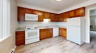 Located at 4665 Kipling St in Wheat Ridge, Colorado, this three-bedroom, one-bathroom unit delivers a practical and efficient single-floor layout. The kitchen is a functional standout, featuring warm wood cabinetry, light granite-style countertops, light wood-look vinyl flooring, and white appliances including a range, dishwasher, microwave, and refrigerator. The spacious primary bedroom offers generous closet space with double doors and plush carpeting, while the two additional bedrooms each include closets and windows with vertical blinds that invite natural light. Baseboard heating is present throughout the bedrooms, ensuring consistent warmth. The living area is carpeted and open, with a window and wall-unit air conditioner, providing a comfortable gathering space. A hallway connects the main areas of the unit seamlessly. The full bathroom is clean and bright, featuring a tiled tub-shower combination with chrome fixtures and a white vanity. Neutral wall tones and clean finishes throughout create a cohesive, move-in ready atmosphere. This unit offers a compact yet complete layout well-suited for those seeking straightforward, functional living in the Wheat Ridge area.