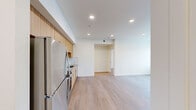 Located at 6988 N Nevada St in Spokane, WA, this thoughtfully designed two-bedroom, one-bathroom unit offers a clean, contemporary aesthetic across a single floor. Light wood-toned luxury vinyl flooring runs throughout, creating a cohesive and easy-to-maintain living environment.

The open kitchen is a standout feature, showcasing warm wood-grain cabinetry extending to the ceiling, stainless steel appliances including a refrigerator, electric range, microwave, and dishwasher, complemented by a light tile backsplash and a stainless sink. Recessed lighting illuminates the space efficiently.

Both bedrooms are bright and functional, each benefiting from natural light through blinded windows. The primary bedroom is a comfortable size and, along with at least one other room, is equipped with a wall-mounted ductless mini-split unit for individualized heating and cooling. An electrical panel is conveniently accessible within the unit.

The bathroom features a full bathtub with a shower, a clean white finish, and accessibility-friendly grab bars along the walls, alongside wood-toned flooring that ties into the rest of the home.

A dedicated entrance and hallway provide a practical flow between rooms. The overall palette of whites and warm wood tones gives the unit a fresh, modern feel suited for comfortable everyday living.