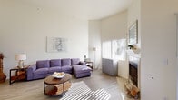Located in Las Vegas, NV, this 2-bedroom, 3-bathroom residence offers a well-designed single-floor layout that maximizes comfort and functionality. The living room immediately impresses with its soaring ceilings and generous natural light streaming through large windows, highlighting the wood-style flooring and a classic tiled fireplace — a standout architectural feature. The open layout flows seamlessly into the dining area, which is anchored by a pendant light fixture and floor-to-ceiling vertical blinds that lead to an outdoor patio, offering pleasant views of the surrounding greenery.

The kitchen is efficiently designed in a U-shape configuration, featuring white cabinetry, light countertops, a double-basin sink, and a full suite of white appliances including a gas range, built-in microwave, dishwasher, and refrigerator. A window above the sink brings in additional natural light.

The primary bedroom is a spacious retreat with plush carpeting, a large window, and ample room for rest and relaxation. The secondary bedroom also features carpeted flooring and a bright window with outdoor views. The bathrooms are well-appointed, with at least one featuring a full soaking tub surrounded by tile surround. This residence offers a clean, neutral palette throughout, creating a calm and inviting ambiance.