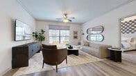 Located at 1401 Aschinger Blvd in Columbus, Ohio, this 2-bedroom, 3-bathroom residence offers a well-organized single-floor layout designed for comfortable, modern living. The open-concept living room and kitchen area serves as the heart of the home, featuring light wood-tone flooring, crown molding, and multiple windows that fill the space with natural light. A ceiling fan adds to the airy feel of the living room, which offers ample room for relaxed seating arrangements. The kitchen is outfitted with dark cabinetry, granite countertops, a subway tile backsplash, and stainless steel appliances, creating a sleek and functional cooking environment. Both bedrooms are carpeted and bright, with the spacious primary suite offering room for a full bedroom set and direct access to a well-appointed closet. The bathrooms feature granite vanities with dark cabinetry, wood-look vinyl flooring, and tiled tub-shower combinations. A dedicated laundry room houses a full-size washer and dryer. Two closets, including a walk-in with wire shelving, provide excellent storage. The overall aesthetic is clean and contemporary, with neutral tones throughout creating a cohesive and inviting atmosphere.