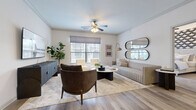 Located at 1401 Aschinger Blvd in Columbus, Ohio, this 2-bedroom, 3-bathroom residence offers a well-organized single-floor layout designed for comfortable, modern living. The open-concept living room and kitchen area serves as the heart of the home, featuring light wood-tone flooring, crown molding, and multiple windows that fill the space with natural light. A ceiling fan adds to the airy feel of the living room, which offers ample room for relaxed seating arrangements. The kitchen is outfitted with dark cabinetry, granite countertops, a subway tile backsplash, and stainless steel appliances, creating a sleek and functional cooking environment. Both bedrooms are carpeted and bright, with the spacious primary suite offering room for a full bedroom set and direct access to a well-appointed closet. The bathrooms feature granite vanities with dark cabinetry, wood-look vinyl flooring, and tiled tub-shower combinations. A dedicated laundry room houses a full-size washer and dryer. Two closets, including a walk-in with wire shelving, provide excellent storage. The overall aesthetic is clean and contemporary, with neutral tones throughout creating a cohesive and inviting atmosphere.