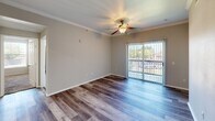 Located at 3131 SW 89th St in Oklahoma City, OK, this single-story, 3-bedroom, 2-bathroom home offers a functional and comfortable layout across a well-utilized floor plan. The living area features wood-look flooring, crown molding, a tray ceiling detail, and a ceiling fan, with sliding glass doors that invite natural light and provide outdoor views. The kitchen is equipped with stainless steel appliances—including a refrigerator, range, and dishwasher—complemented by white cabinetry, light countertops, and a range hood, all set over matching wood-look flooring. The bedrooms are carpeted and include ceiling fans; the primary bedroom is generously sized, while the additional bedrooms each feature windows with blinds that allow for ample natural light. The bathrooms are clean and bright, with one featuring a wide vanity with dual sinks, a large mirror, white cabinetry, and a tiled soaking tub and shower combo. A dedicated in-unit laundry room houses a full-size washer and dryer with overhead shelving. Two closets and a hallway complete the interior, offering practical storage throughout the home.