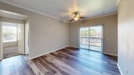 Located at 3131 SW 89th St in Oklahoma City, OK, this single-story, 3-bedroom, 2-bathroom home offers a functional and comfortable layout across a well-utilized floor plan. The living area features wood-look flooring, crown molding, a tray ceiling detail, and a ceiling fan, with sliding glass doors that invite natural light and provide outdoor views. The kitchen is equipped with stainless steel appliances—including a refrigerator, range, and dishwasher—complemented by white cabinetry, light countertops, and a range hood, all set over matching wood-look flooring. The bedrooms are carpeted and include ceiling fans; the primary bedroom is generously sized, while the additional bedrooms each feature windows with blinds that allow for ample natural light. The bathrooms are clean and bright, with one featuring a wide vanity with dual sinks, a large mirror, white cabinetry, and a tiled soaking tub and shower combo. A dedicated in-unit laundry room houses a full-size washer and dryer with overhead shelving. Two closets and a hallway complete the interior, offering practical storage throughout the home.