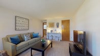 Located at 36 Mt Vernon Dr in Vernon Rockville, Connecticut, this single-floor residence offers a well-organized and functional layout designed for comfortable everyday living. The living room serves as the heart of the home, featuring wall-to-wall carpeting, neutral-toned walls, and natural light streaming through sheer-curtained windows. A ceiling-height baseboard heating system ensures year-round comfort, while the open sightlines create an inviting, airy atmosphere.

The kitchen is outfitted with white cabinetry accented by black hardware, dark laminate countertops, a double-basin sink, and tile flooring. Natural light filters in through multiple windows equipped with blinds, making the space bright and practical. Adjacent to the kitchen is a dedicated dining area with tile flooring, a ceiling fan, and easy access to exterior doors, offering a convenient and casual setting for meals.

The bedroom is carpeted and well-proportioned, featuring a ceiling fan, closet access, and windows that allow natural light. Warm wood-toned trim and doors are consistent throughout the home, lending a cohesive and classic character to the interior. The full bathroom includes tile flooring, a shower-tub combination, a vanity, and baseboard heating. Overall, the residence presents a clean, practical, and comfortable living environment.