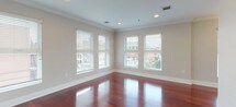 Located at 619 Adams St in Hoboken, NJ, this single-floor residence combines modern finishes with a functional, open layout. Rich, deep-toned hardwood flooring flows throughout the main living areas and bedrooms, adding warmth and visual continuity to the space.

The living and dining areas are generously sized, bathed in natural light from multiple windows fitted with horizontal blinds that frame views of the surrounding Hoboken streetscape. Crown molding and recessed lighting add a refined touch, while an elegant chandelier serves as a focal point in the dining area.

The kitchen features warm wood cabinetry, granite countertops, stainless steel appliances including a refrigerator, microwave, and gas range, and pendant lighting over a large breakfast bar, making it well-suited for both cooking and casual dining.

The bedrooms are comfortably proportioned, each with hardwood floors, neutral painted walls, and windows offering views of the neighborhood. The two bathrooms are finished with large-format earth-toned tiles covering both the floors and walls. One bathroom includes a vanity with a wood cabinet and a dedicated toilet area, while the second features a full bathtub with a tiled surround, completing this well-appointed Hoboken residence.