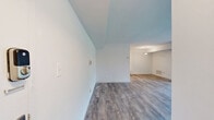 This well-designed single-floor home in Cockeysville, MD offers three bedrooms, one bathroom, and a comfortable, functional layout. The living room is bright and airy, anchored by large sliding glass doors that fill the space with natural light and provide picturesque views of lush greenery outside. Wood-style plank flooring runs throughout the main living areas, adding warmth and a clean, contemporary feel.

The kitchen is a standout feature, boasting rich dark cabinetry, granite countertops, stainless steel appliances including a gas range, built-in microwave, and refrigerator, complemented by a white tile backsplash and pendant lighting overhead. A breakfast bar adds casual dining convenience and connects the kitchen to the living space seamlessly.

The three bedrooms are comfortably sized, with plush carpeting underfoot. The generously proportioned primary bedroom offers ample space for a full furniture arrangement. Additional bedrooms feature large windows with views of the surrounding landscape, allowing for natural light throughout.

The bathroom is clean and functional, featuring a wood-toned vanity with a white countertop, a large mirror, and a glass-enclosed shower. Two closets provide practical storage solutions. Overall, this home offers a thoughtful blend of modern updates and comfortable living in a well-maintained setting.
