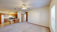 Located at 2407 Hampshire Drive in Champaign, Illinois, this single-floor, two-bedroom, two-bathroom unit offers a practical and comfortable layout with consistent finishes throughout. The kitchen is well-appointed with warm oak cabinetry, gray laminate countertops, and tile flooring. It includes a full suite of appliances — electric range, dishwasher, and refrigerator — along with ample cabinet storage and a ceiling fan overhead. The kitchen connects directly to the main living area and provides easy access to multiple doorways leading to the rest of the unit. Both bedrooms feature plush carpeting, ceiling fans with lighting, and natural light from windows overlooking the surrounding neighborhood. Each bedroom includes a built-in closet with bifold wood doors for convenient storage. The primary bedroom offers a notably spacious feel. The two bathrooms are clean and functional, each featuring oak cabinetry for added storage. One bathroom includes a full tub-shower combination with chrome fixtures, while both are finished with tile flooring. A connecting hallway ties all rooms together efficiently. Throughout the unit, warm wood-toned trim and neutral wall tones create a cohesive, understated aesthetic well-suited for everyday living.