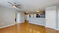 Located at 1380 Saylor Dr in Zionsville, Indiana, this single-floor, 3-bedroom, 2-bathroom home offers a well-designed layout with consistent finishes throughout. The open-concept living and kitchen area forms the heart of the home, featuring warm hardwood-style flooring, neutral gray walls, and a ceiling fan that enhances the airy feel. The kitchen is equipped with rich dark cabinetry, granite countertops, black appliances including a range and built-in microwave, and a peninsula with an integrated sink and pendant lighting above — ideal for both cooking and casual dining. The living room extends naturally from the kitchen, with a door providing direct outdoor access and a window that brings in natural light. Each of the three bedrooms is carpeted and fitted with a ceiling fan. The spacious primary bedroom offers generous room, while the secondary bedrooms feature windows that allow ample natural light. With five closets distributed across the home, storage is plentiful. Both bathrooms mirror each other in design, featuring granite-topped dark wood vanities, hardwood-style flooring, and full tub-shower combinations with white tile surrounds. A dedicated utility room rounds out the functional layout of this well-appointed Zionsville home.