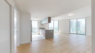 Located in the heart of Miami's Arts & Entertainment District, this high-rise unit offers a sleek, contemporary design with an open-concept layout bathed in abundant natural light. Light-toned hardwood flooring flows consistently throughout the living spaces, complementing the crisp white walls and clean modern aesthetic.

The open-plan living and dining area is expansive, anchored by floor-to-ceiling sliding glass doors that frame striking panoramic views of the Miami skyline and Biscayne Bay, allowing sunlight to pour in throughout the day. The kitchen is thoughtfully integrated into the open living space and features a granite-topped island, stainless steel appliances including a refrigerator, microwave, and range, dark wood cabinetry with frosted glass upper cabinets, and additional floor-to-ceiling windows that reinforce the connection to the city views beyond.

The bedrooms continue the light and airy theme, each finished with the same hardwood flooring and large windows offering city views. The bathrooms are finished with large-format neutral tile, warm wood vanity cabinetry, granite countertops, undermount sinks, chrome fixtures, and full soaking tubs. The overall ambiance is clean, bright, and contemporary, reflecting a modern urban lifestyle in one of Miami's most vibrant neighborhoods.