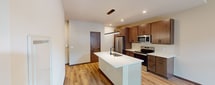 This contemporary 600 square foot apartment in Madison, Wisconsin offers a blend of style and functionality. The open-concept design maximizes space, creating a seamless flow between the living areas. The gourmet kitchen is a standout feature, boasting modern wood cabinetry, stainless steel appliances, and a striking white quartz countertop with an island that doubles as a dining space.

The spacious bathroom features a large vanity with ample storage and a sleek design. The bedroom, measuring 130 square feet, provides a cozy retreat with large windows that flood the space with natural light and offer city views. Throughout the apartment, light wood-look flooring adds warmth and complements the neutral color palette.

Recessed lighting and modern fixtures, including a unique linear pendant over the kitchen island, enhance the apartment's contemporary aesthetic. The unit also includes a closet for additional storage. With its thoughtful design and prime location at 531 W Washington, this apartment offers a perfect blend of urban living and comfort in the heart of Madison.