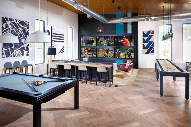 Catch multiple games and even play a few in our game room - Pace Apartments