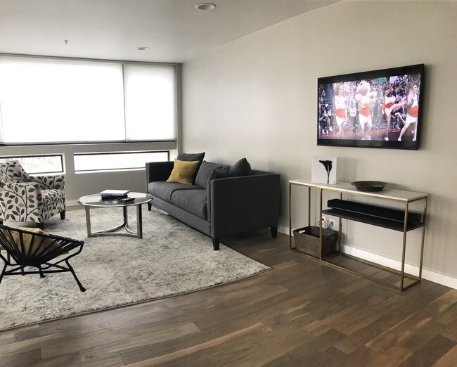 living room with flat screen TV and Sonos sound system - 121 S Hope St