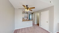 Located at 10229 Desmond Pl in Perrysburg, Ohio, this one-bedroom, one-bathroom residence offers a practical and comfortable layout across a single floor. The open-concept living area is finished with soft carpeting and neutral gray walls, creating a clean and inviting atmosphere. A ceiling fan with integrated lighting anchors the space, while natural light filters in through slatted blinds.

The kitchen is positioned adjacent to the living area and features a peninsula with a double stainless steel sink and granite-style countertops. White cabinetry provides ample storage, complemented by track lighting overhead, hardwood-style flooring, and white appliances including a refrigerator, electric range, and over-the-range microwave.

The bedroom is a comfortable, well-proportioned room with plush carpeting, soft natural light from a window with blinds, and access to a dedicated walk-in closet with built-in shelving and hanging rods. An additional door leads into the hallway, connecting the room to the rest of the home.

The bathroom includes a full soaking tub with a shower, a clean white surround, a chrome shower rod, and gray-toned walls that lend a modern, understated aesthetic. A hallway connects all rooms with efficient flow. The space is designed with simplicity and functionality in mind, making it an ideal home in the Perrysburg community.