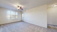 Located at 4229 Stonecrest Dr in Burlington, NC, this one-bedroom, one-bathroom residence offers a practical and comfortable single-floor layout. The living room is a welcoming, open space featuring plush wall-to-wall carpeting, a ceiling fan, and multiple windows fitted with blinds that allow natural light to fill the room. A glass-paneled exterior door provides additional brightness and outdoor access. The kitchen is designed for functionality, showcasing warm honey-toned cabinetry, granite-style countertops, a double stainless steel sink, and black appliances including a refrigerator, range, microwave, and dishwasher, all set on light wood-look flooring. The bedroom offers a comfortable retreat with soft carpeting, a ceiling fan, and a large window that bathes the room in natural light, along with a dedicated closet. The full bathroom is well-appointed with a soaking tub and shower combination, a warm wood-toned vanity with white countertop, a large mirror, and wood-look flooring. A dedicated laundry room includes washer and dryer hookups and overhead wire shelving for added storage. The hallway connects all spaces seamlessly, completing this efficiently designed and move-in-ready residence.