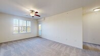 Located at 4229 Stonecrest Dr in Burlington, NC, this one-bedroom, one-bathroom residence offers a practical and comfortable single-floor layout. The living room is a welcoming, open space featuring plush wall-to-wall carpeting, a ceiling fan, and multiple windows fitted with blinds that allow natural light to fill the room. A glass-paneled exterior door provides additional brightness and outdoor access. The kitchen is designed for functionality, showcasing warm honey-toned cabinetry, granite-style countertops, a double stainless steel sink, and black appliances including a refrigerator, range, microwave, and dishwasher, all set on light wood-look flooring. The bedroom offers a comfortable retreat with soft carpeting, a ceiling fan, and a large window that bathes the room in natural light, along with a dedicated closet. The full bathroom is well-appointed with a soaking tub and shower combination, a warm wood-toned vanity with white countertop, a large mirror, and wood-look flooring. A dedicated laundry room includes washer and dryer hookups and overhead wire shelving for added storage. The hallway connects all spaces seamlessly, completing this efficiently designed and move-in-ready residence.