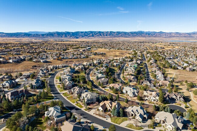A curved street in Highlands Ranch is lined with views of the Front Range.