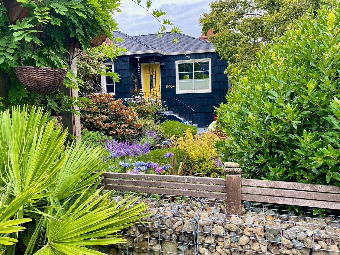 This is the front of the house. The ADU's entrance is via a private gate on the side. - 11639 1st Ave NW