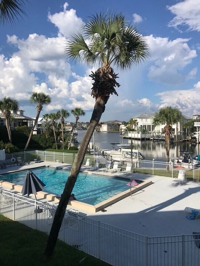 View from private balcony overlooks pool and canal - 501 Gulf Shore Dr