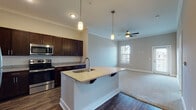 Located at 9110 Crowne Springs View in Colorado Springs, Colorado, this single-floor residence offers a thoughtfully designed open-concept layout finished with quality materials throughout. Crown molding adds a refined touch to the main living areas, while a combination of wood-style hard flooring and plush carpeting defines each zone of the home.

The kitchen serves as a central focal point, anchored by a sizeable island with a granite countertop, an undermount sink, and pendant lighting overhead. Rich, dark-toned cabinetry lines the walls and provides generous storage, complemented by a classic white subway tile backsplash. Stainless steel appliances, including a refrigerator, range, microwave, and dishwasher, complete the well-equipped space.

The open layout flows seamlessly into the living area, which features a ceiling fan and natural light from windows with blinds. A door from this room appears to lead to an outdoor area, enhancing the connection to the exterior.

The bedrooms are carpeted and comfortably sized, each with ceiling fans and windows that allow natural light to filter in. One bedroom includes access to a walk-in closet. The bathroom features wood-style flooring, a granite-topped vanity with dark cabinetry, and a tub-shower combination, maintaining the consistent design language found throughout the home.