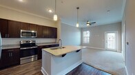 Located at 9110 Crowne Springs View in Colorado Springs, Colorado, this single-floor residence offers a thoughtfully designed open-concept layout finished with quality materials throughout. Crown molding adds a refined touch to the main living areas, while a combination of wood-style hard flooring and plush carpeting defines each zone of the home.

The kitchen serves as a central focal point, anchored by a sizeable island with a granite countertop, an undermount sink, and pendant lighting overhead. Rich, dark-toned cabinetry lines the walls and provides generous storage, complemented by a classic white subway tile backsplash. Stainless steel appliances, including a refrigerator, range, microwave, and dishwasher, complete the well-equipped space.

The open layout flows seamlessly into the living area, which features a ceiling fan and natural light from windows with blinds. A door from this room appears to lead to an outdoor area, enhancing the connection to the exterior.

The bedrooms are carpeted and comfortably sized, each with ceiling fans and windows that allow natural light to filter in. One bedroom includes access to a walk-in closet. The bathroom features wood-style flooring, a granite-topped vanity with dark cabinetry, and a tub-shower combination, maintaining the consistent design language found throughout the home.