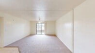 Located at 7310 Penzance Blvd in Fort Myers, Florida, this two-bedroom, one-bathroom unit offers a well-organized single-floor layout designed for comfortable everyday living. The spacious living room is finished with plush carpeting and features a ceiling fan, with a sliding glass door that opens to a private balcony, filling the room with natural light and providing pleasant outdoor views. The kitchen is thoughtfully designed with light tile flooring, cream cabinetry, a granite-style countertop peninsula, and white appliances including a refrigerator, range, and dishwasher — ideal for both casual meals and entertaining. A window above the sink brings in additional natural light. The primary bedroom is generously sized with soft carpeting, a ceiling fan with light fixture, and a dedicated closet. The second bedroom offers similar carpeted comfort with its own ceiling fan. Both rooms connect conveniently to the hallway. The full bathroom features light tile flooring, a shower-tub combination, a vanity with a granite-style countertop, and clean white finishes throughout. A hallway with a closet provides added storage. The unit's neutral color palette and bright interiors create a clean, welcoming ambiance throughout.