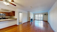 Located at 2070 Hassell Rd in Hoffman Estates, IL, this single-floor residence offers a well-appointed and functional layout. The expansive living area is a highlight of the space, featuring warm hardwood flooring that extends throughout, a ceiling fan, and a fireplace that serves as a central focal point. Large sliding glass doors flood the living area with natural light and open to a private balcony, providing pleasant outdoor views.

The kitchen is thoughtfully designed with rich wood cabinetry, granite countertops, stainless steel appliances including a dishwasher and microwave, and a convenient pass-through counter that connects to the living area, creating an open and sociable feel.

The bedrooms are carpeted for comfort, each featuring individual wall-mounted air conditioning units and windows that allow natural light to filter in. The bathroom is clean and functional, finished with tile flooring, white subway-tiled tub and shower surrounds, and a wood vanity complemented by granite countertops.

Throughout the residence, consistent design choices — including wood trim accents and neutral color palettes — contribute to a cohesive and inviting ambiance, making this a well-rounded space in a convenient Hoffman Estates location.