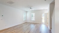 Located at 1491 Bees Ferry Road in Charleston, SC, this two-story home offers a thoughtfully designed layout across two floors. The main level features a bright, open living room with light hardwood flooring, a ceiling fan, and multiple windows with white blinds that invite abundant natural light. The modern kitchen is well-appointed with white shaker cabinetry, white quartz countertops, stainless steel appliances, a single-basin sink, and recessed lighting — complemented by a separate pantry for additional storage. A patio and fenced backyard with serene views of surrounding trees provide a peaceful outdoor retreat. An attached garage with an automatic opener completes the ground floor. Upstairs, three carpeted bedrooms each feature windows and closets, including a generously sized primary bedroom with its own dedicated closet. The three bathrooms are finished with light wood-style flooring, white vanities with quartz countertops, and glass-enclosed showers. A dedicated laundry space and ample hallway storage add everyday convenience. Throughout the home, a clean, neutral color palette and modern finishes create a bright, move-in-ready atmosphere.