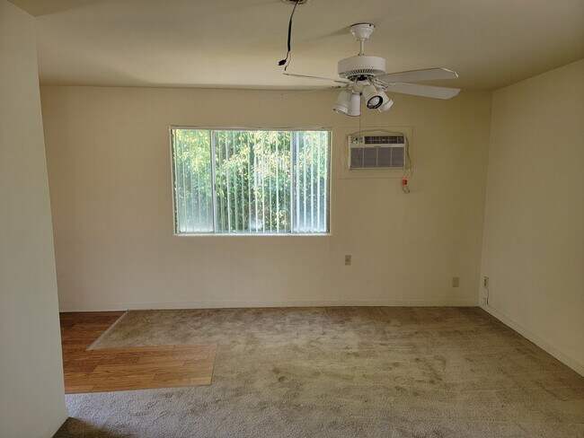 Living room with new vertical blinds & carpet - 424 W Badillo St