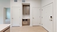 This 870 square foot apartment in Salt Lake City offers a blend of modern design and practical living. The space features three bedrooms, including a primary bedroom of 130 square feet, and two full bathrooms. The single-floor layout maximizes efficiency and flow throughout the home.

The kitchen is a highlight, boasting stainless steel appliances, including a large refrigerator and range. Light-toned cabinetry complements the white backsplash and countertops, creating a bright and airy feel. A convenient built-in microwave nook adds to the kitchen's functionality.

Bathrooms are thoughtfully designed with wood-toned vanities, white fixtures, and combination shower/tub units. The light wood-look flooring runs throughout the apartment, unifying the space and enhancing its modern aesthetic.

Bedrooms are generously sized, with ample closet space featuring sliding doors for a sleek appearance. Large windows in the bedrooms and living areas flood the rooms with natural light and offer views of the surrounding neighborhood.

The apartment's neutral color palette, predominantly in whites and light wood tones, creates a canvas for personal style. Recessed lighting and contemporary fixtures add to the overall modern ambiance. With its efficient use of space and updated finishes, this apartment presents an attractive option for urban living in Salt Lake City.