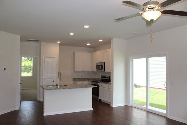 Building Photo - Sun-Filled 3-Story End-Unit Townhome with Fenced Yard, Storage & Resort-Style Pool