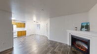 Located at 2501 NE 138th Ave in Vancouver, WA, this single-floor 2-bedroom, 2-bathroom home offers a practical and comfortable layout. The open living, dining, and kitchen area serves as the heart of the home, featuring durable wood-style flooring, a ceiling fan, and a white-mantled electric fireplace that adds warmth and character to the space. Natural light filters in through windows, keeping the area bright and welcoming.

The kitchen is well-equipped with warm wood cabinetry, a white appliance suite including a refrigerator, dishwasher, and electric range, plus ample counter space and a pantry for additional storage. A dedicated laundry room and multiple closets throughout add to the home's functionality.

Both bedrooms feature soft carpeting and closet storage. The primary bedroom connects conveniently to one of the two full bathrooms, which features wood-style flooring, a vanity with warm wood cabinetry, and a shower-tub combination. The second bathroom mirrors a similar clean, functional design.

A hallway connects the main living spaces to the bedrooms, and a private patio provides outdoor access. The home's crisp white walls and consistent flooring create a clean, cohesive aesthetic throughout.