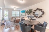 Located at Golden Bear Drive in Moseley, Virginia, this single-floor residence offers a thoughtfully designed layout that balances functionality with comfortable living. The open-concept kitchen and dining area serves as a central hub, featuring dark espresso cabinetry, granite-style countertops, black appliances, and hardwood-style flooring that extends throughout the main living areas. Pendant lighting above the breakfast bar adds a refined touch, while the adjacent dining space accommodates a full table with ease.

The living room is generously sized, bathed in natural light from multiple windows with blinds, and features a ceiling fan. Its welcoming ambiance makes it ideal for both relaxing and entertaining.

Two well-proportioned bedrooms each offer plush carpeting, ceiling fans, and windows that invite natural light. The primary bedroom provides ample space for a full furniture suite.

Two bathrooms serve the residence; one features hardwood-style flooring, a wall-mounted sink, and a shower-tub combo, while the second includes dark cabinetry with granite countertops and a tub surround.

A dedicated laundry area houses a full-size GE front-loading washer and dryer alongside an on-demand water heater, adding notable convenience to daily living.